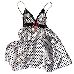 black and white polka dot silk top with coral bow.